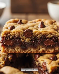 Chocolate chip cookie dough bars stacked on a plate, ready to enjoy.