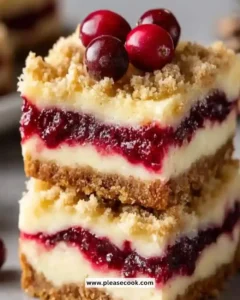 Christmas Cherry Cheesecake Bars topped with cherries on a plate