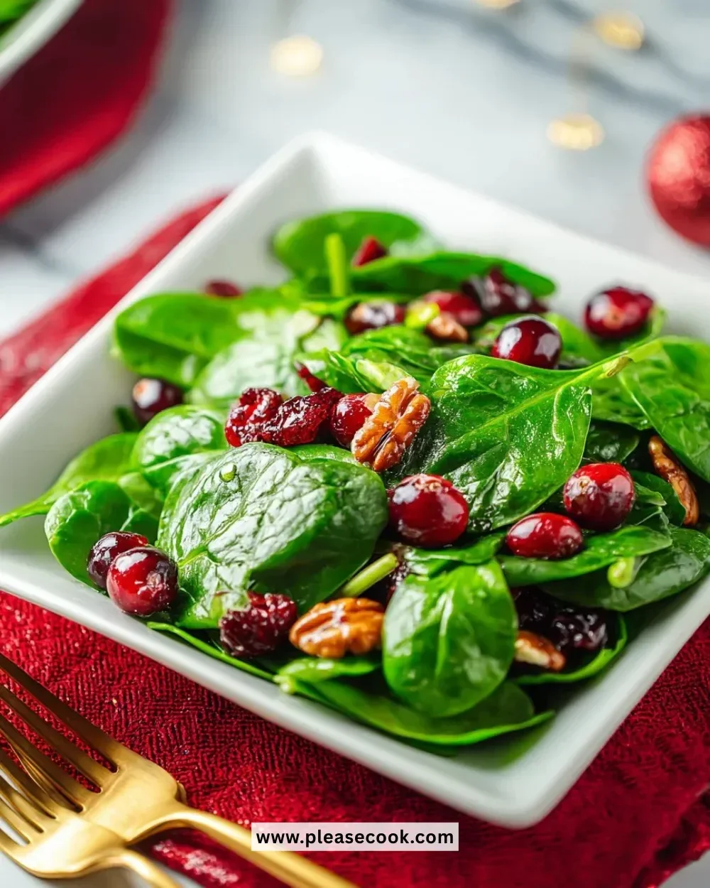 Christmas cranberry spinach salad with vibrant ingredients and festive presentation.