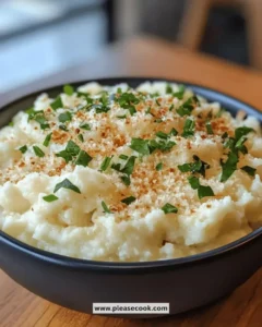 Bowl of creamy garlic parmesan mashed cauliflower topped with parsley