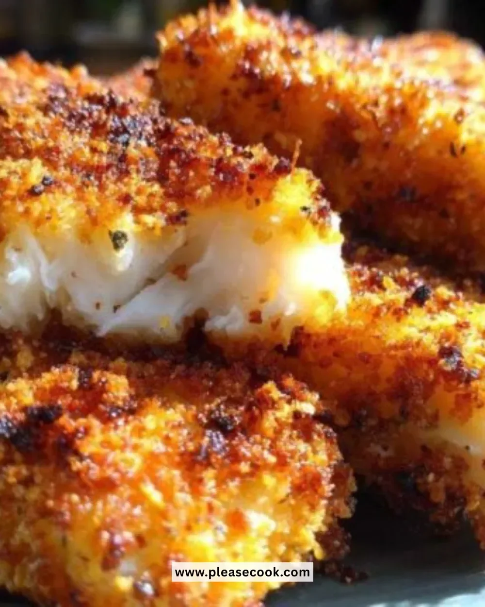 Plate of crispy fish sticks served with dipping sauce