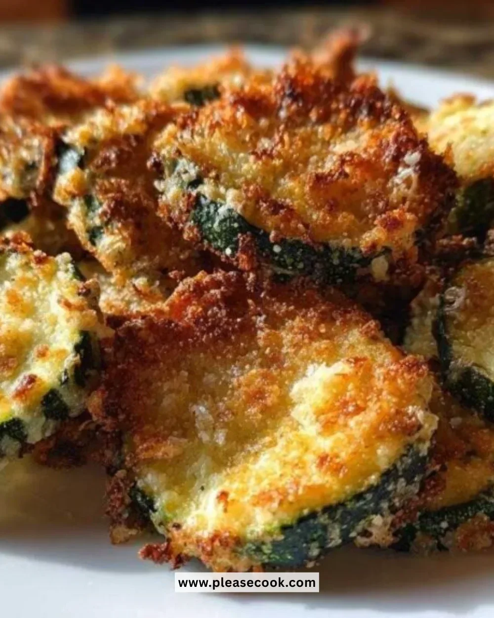 A plate of crispy zucchini parmesan chips, golden and delicious