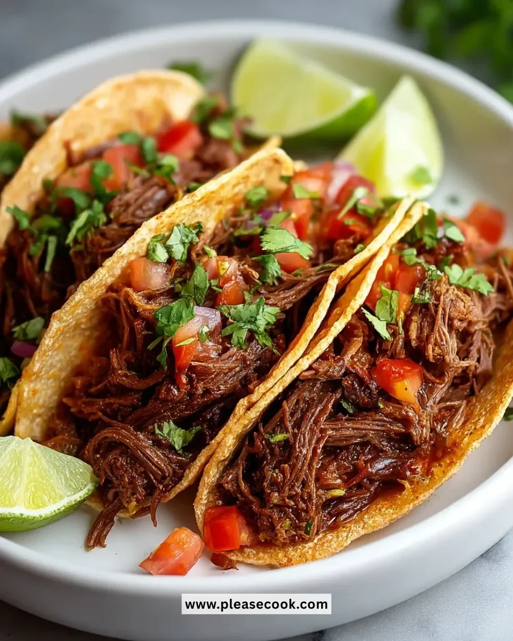 Crockpot Mexican shredded beef tacos served with fresh toppings