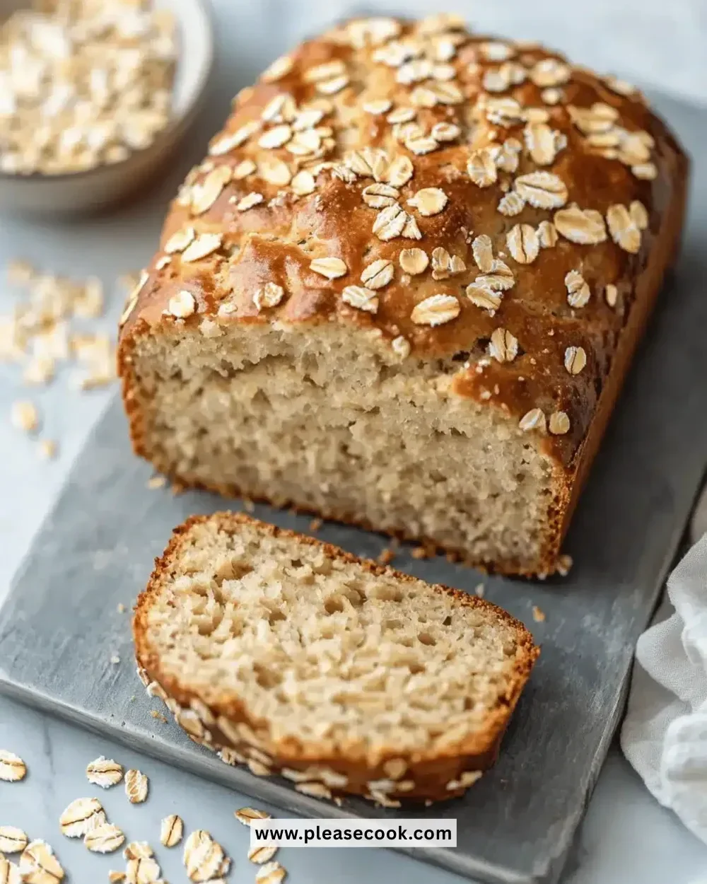 Loaf of delicious Greek yogurt oat bread on a wooden cutting board