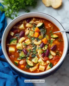 Bowl of Olive Garden Minestrone Soup filled with fresh vegetables and beans.