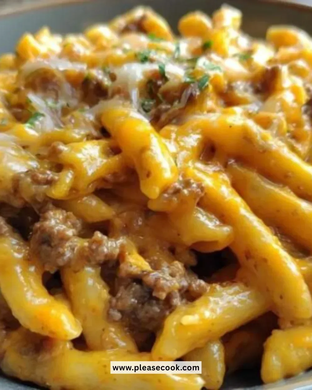 One-Pot Cheeseburger Pasta dish garnished with fresh herbs and cheese.