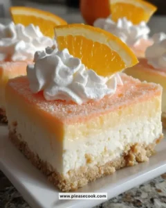 Plate of delicious orange creamsicle dream bars served in summer.