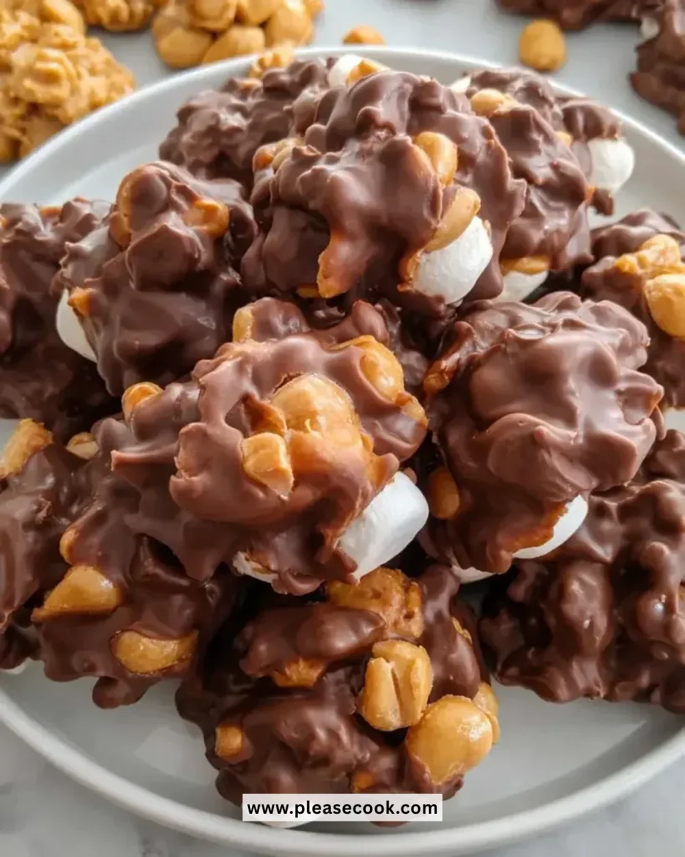 Peanut marshmallow clusters stacked on a plate, showcasing their deliciousness.
