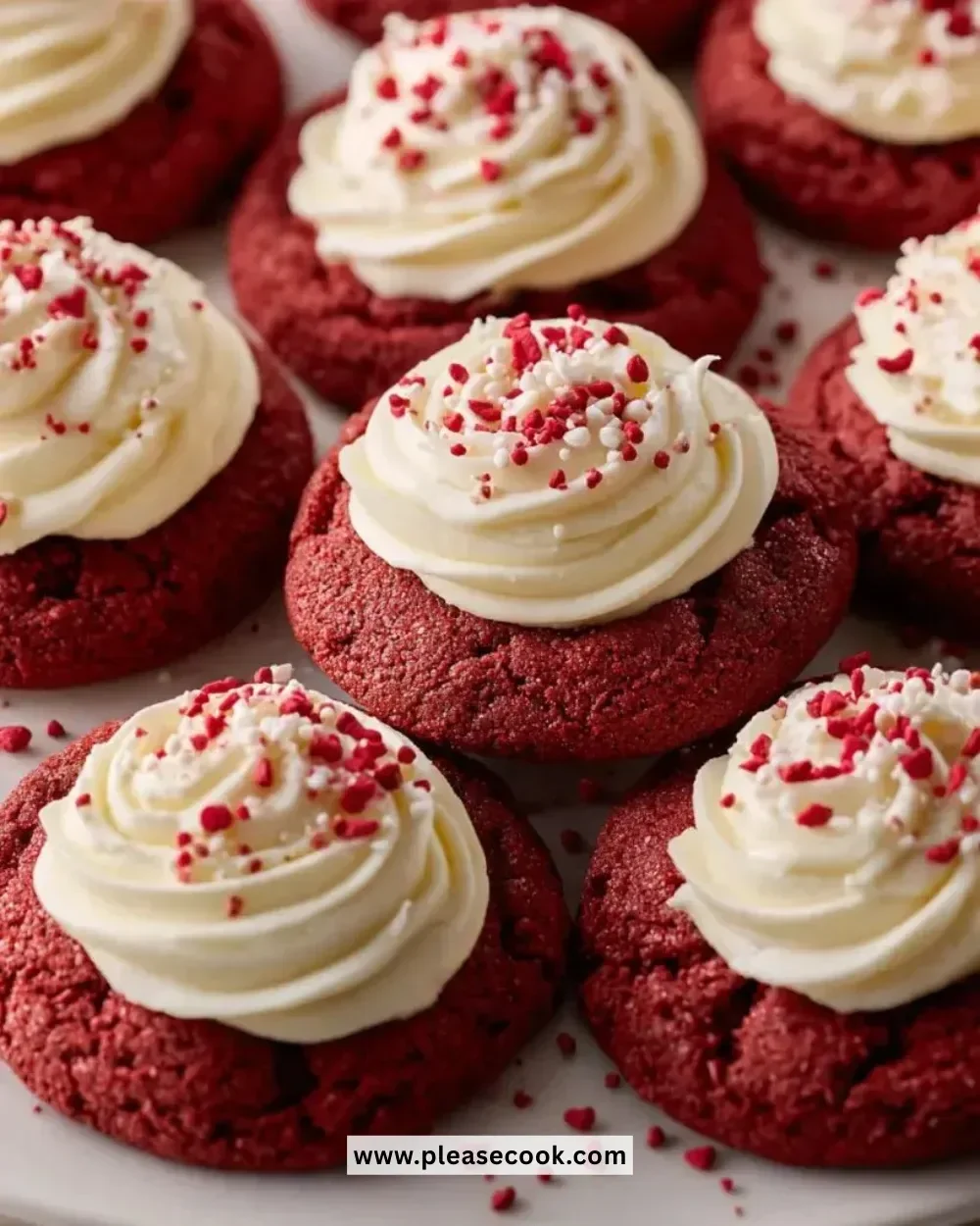 Delicious red velvet cookies with cream cheese frosting on a white plate