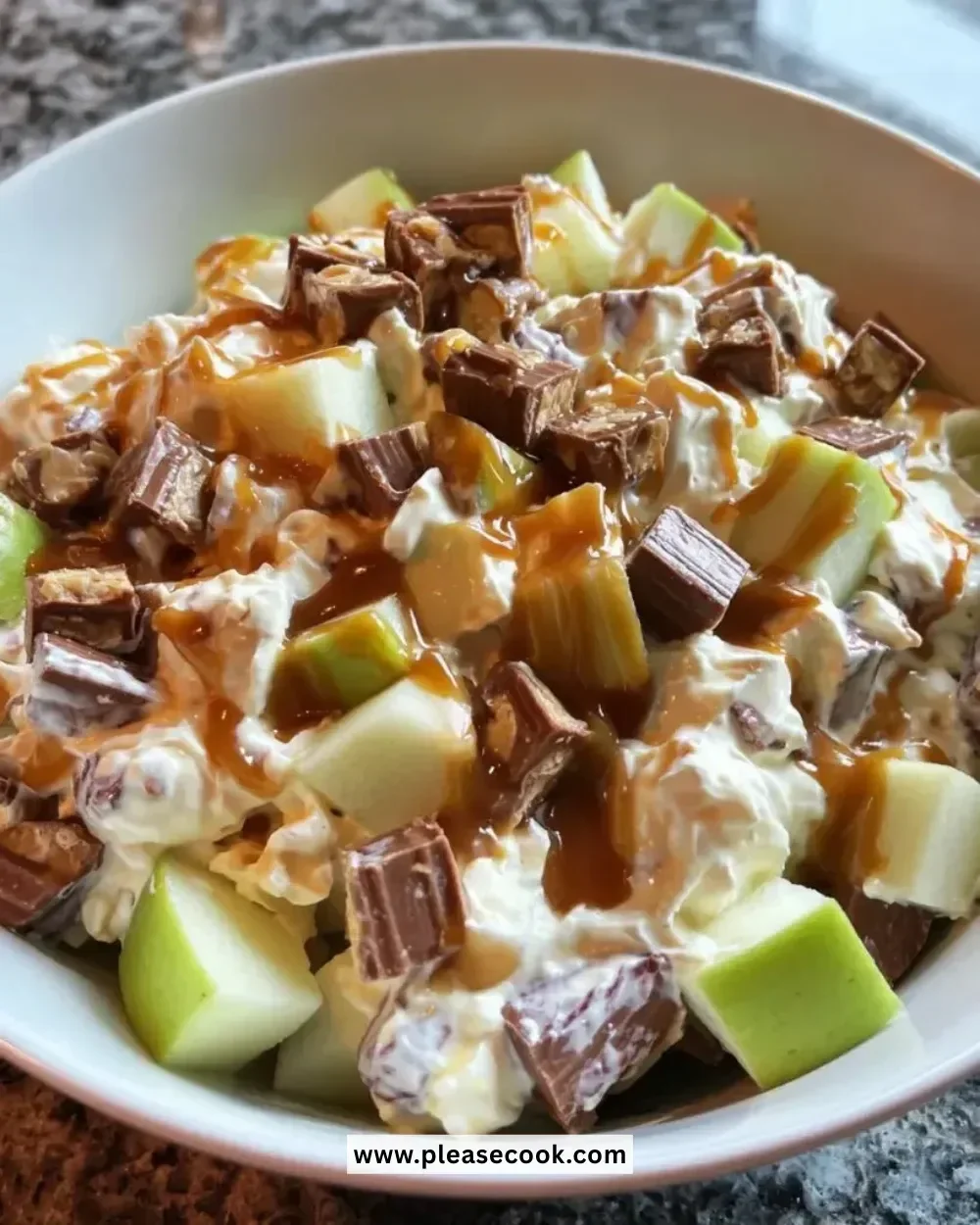 Delicious Snickers caramel apple salad with apples, Snickers, and caramel sauce