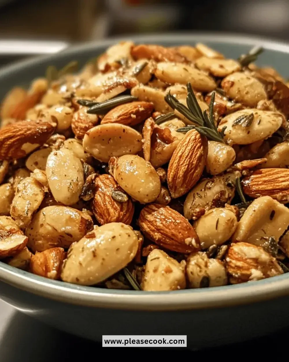 Honey rosemary almond snack mix in a bowl, perfect for healthy snacking.