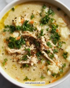 Bowl of anti-inflammatory cauliflower chicken soup garnished with herbs.