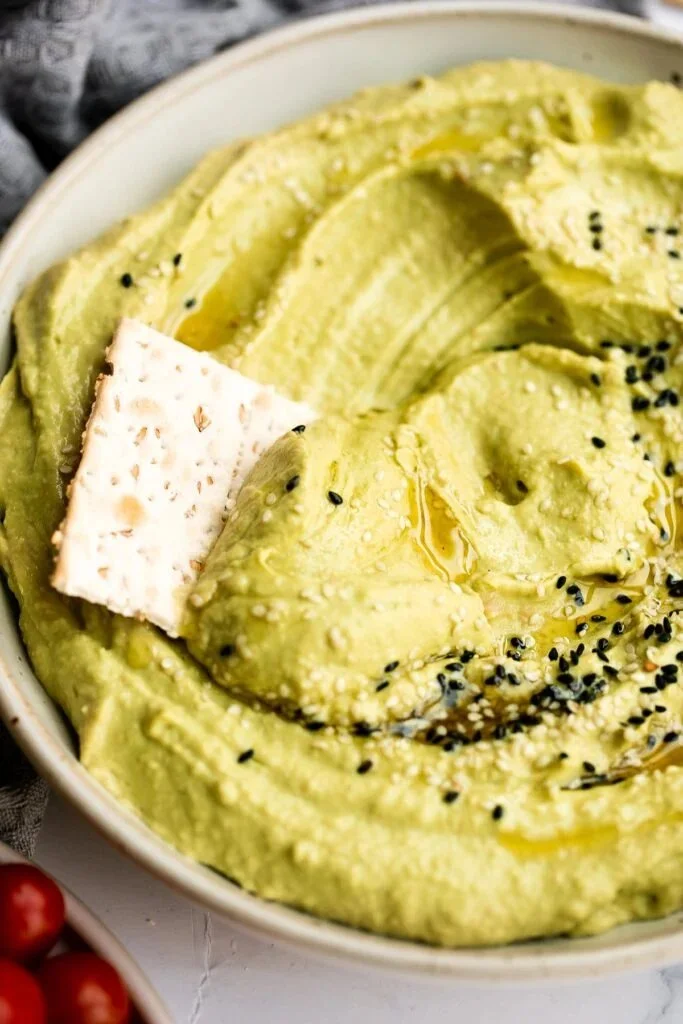 Delicious homemade avocado hummus served with fresh vegetables