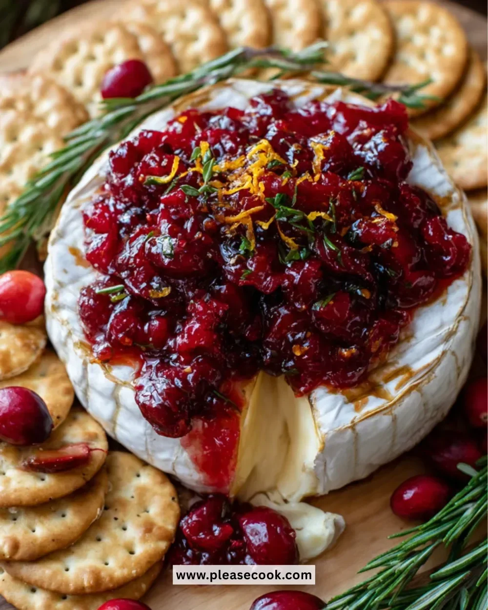 Baked Brie with cranberry sauce served on a wooden board