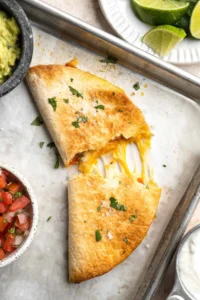Golden baked chicken quesadillas filled with cheese and vegetables