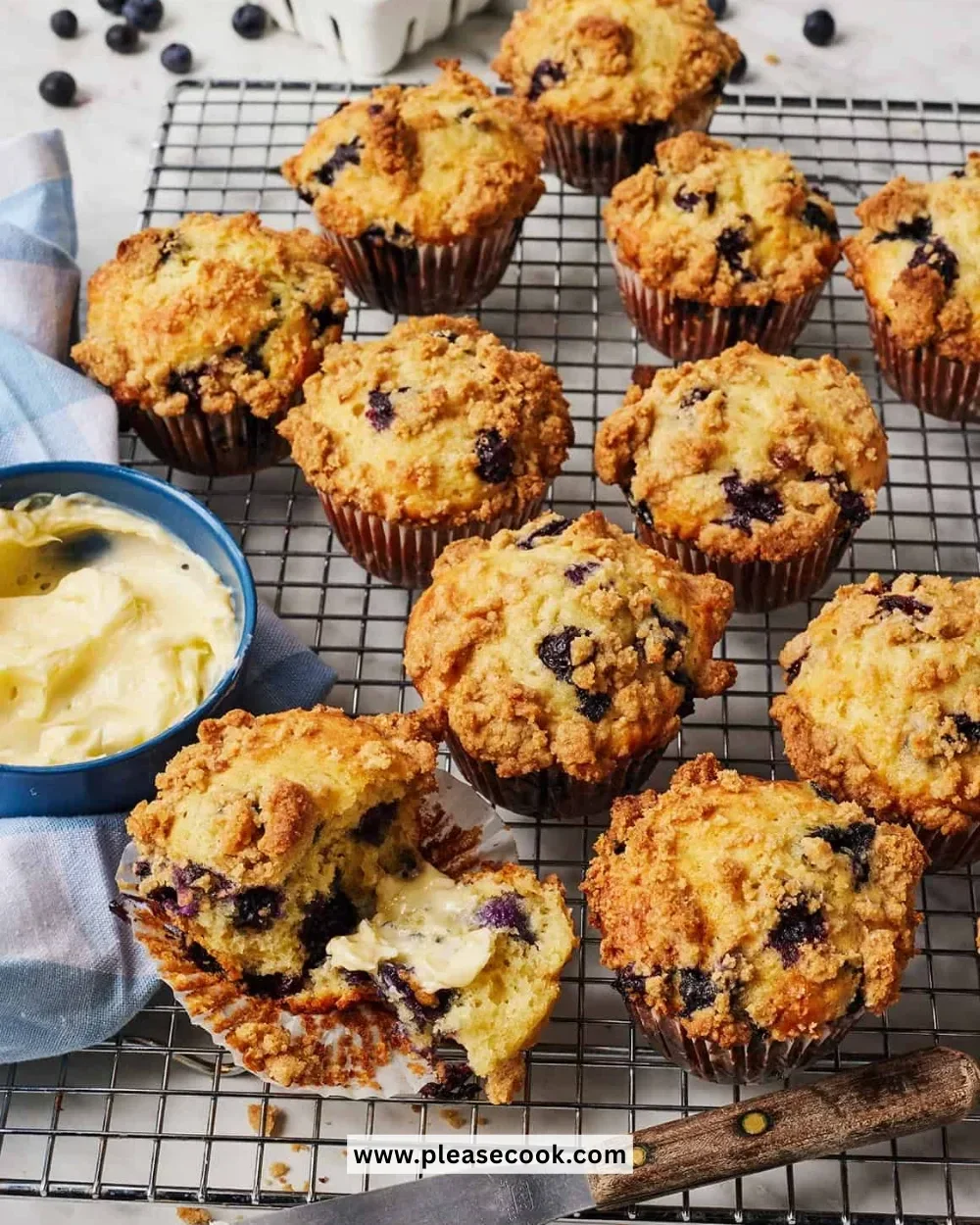 Freshly baked blueberry muffins with plump blueberries on a wooden table