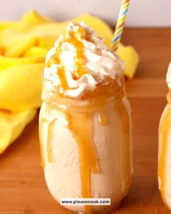 A glass of Bourbon Milk Punch with a sprinkle of nutmeg, showcasing its creamy texture.