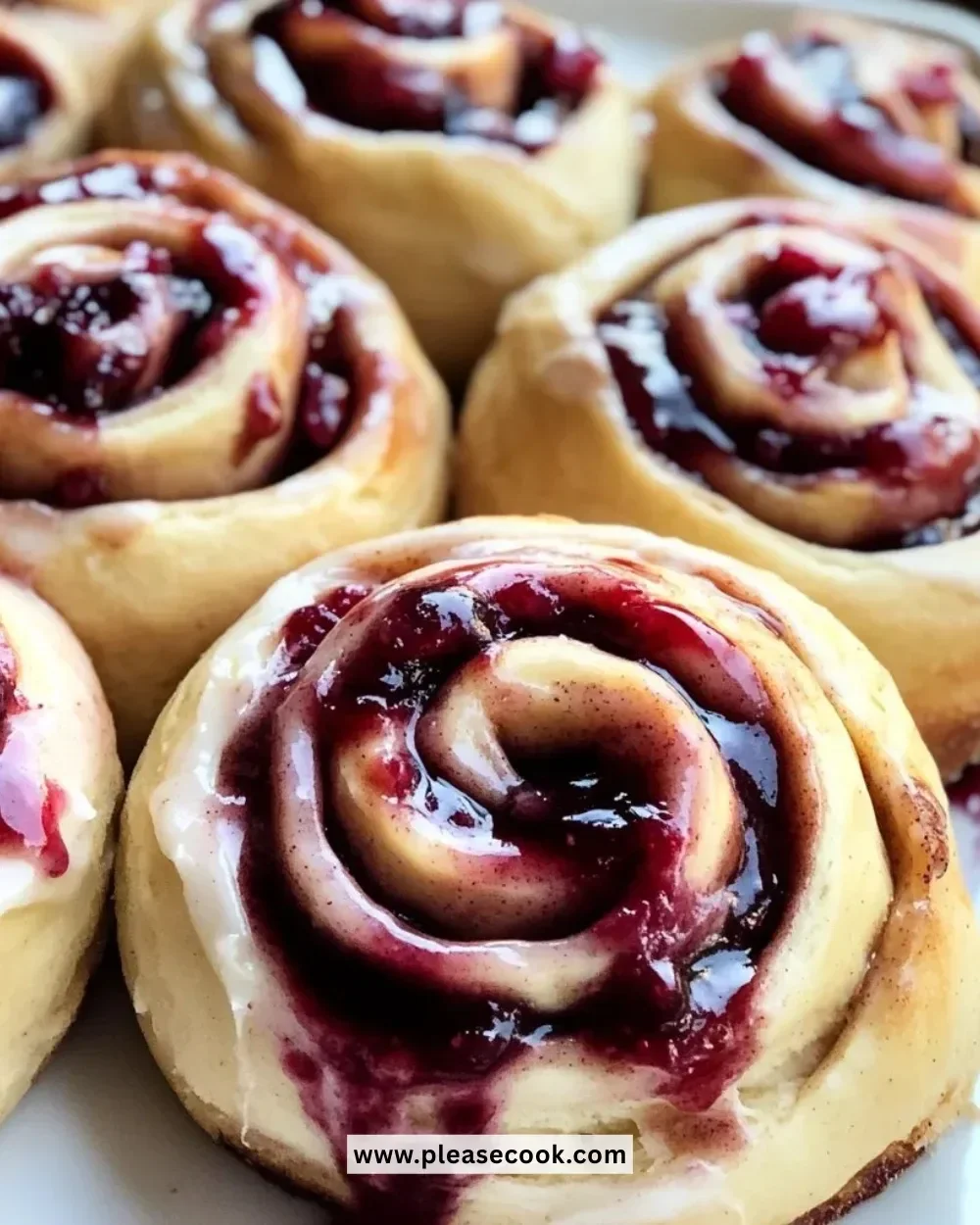 Delicious cherry cinnamon rolls topped with icing and fresh cherries.
