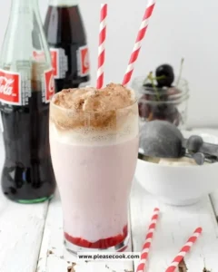 Delicious Cherry-Cola Milkshake topped with whipped cream and cherries