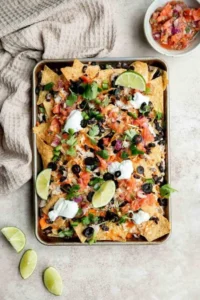 Delicious chicken nachos topped with cheese, jalapenos, and fresh toppings.