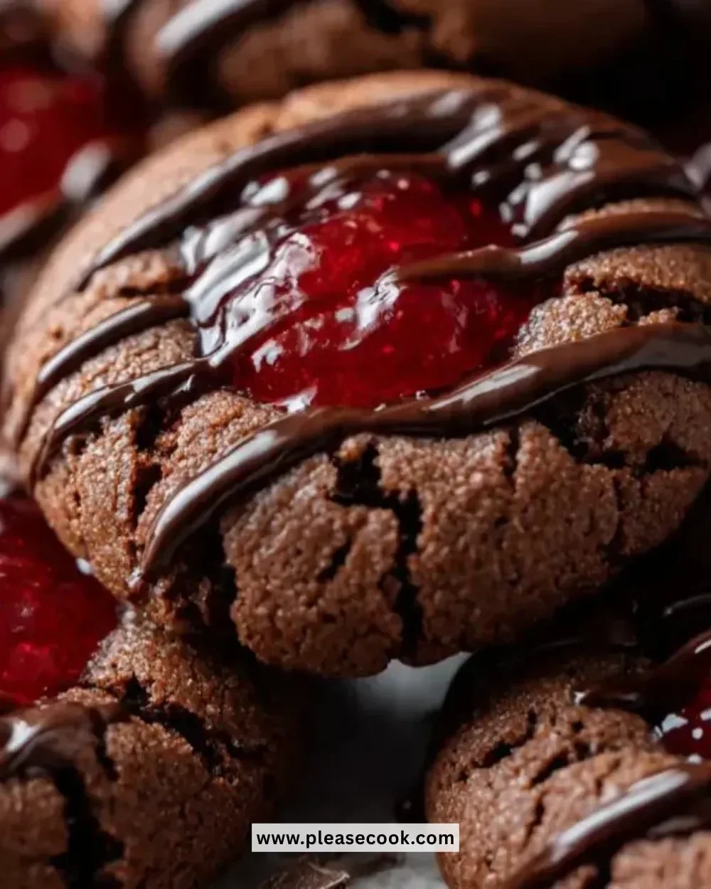 Freshly baked Chocolate Cherry Thumbprint Cookies on a cooling rack.