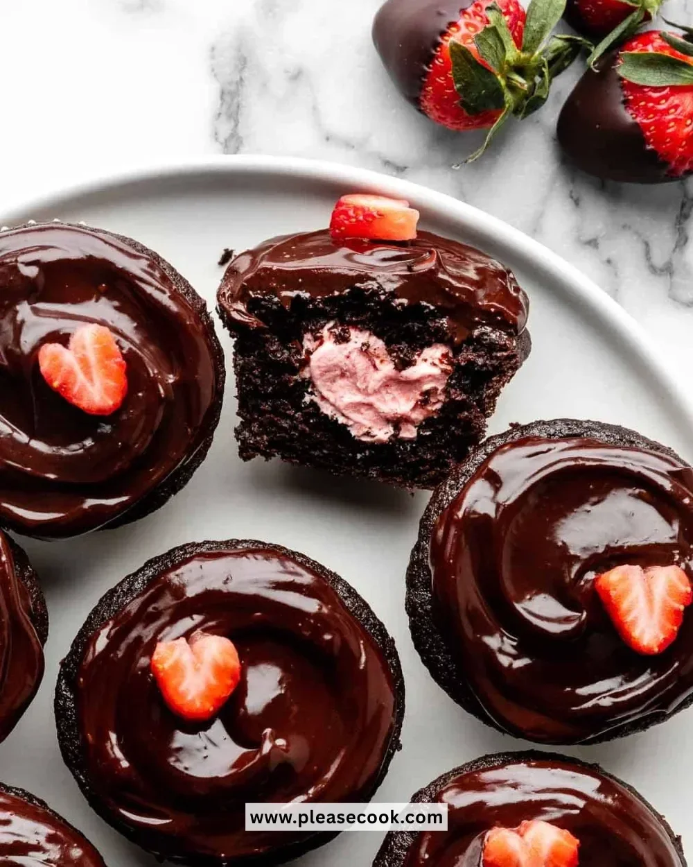 Delicious chocolate covered strawberry cupcakes with fresh berries on top