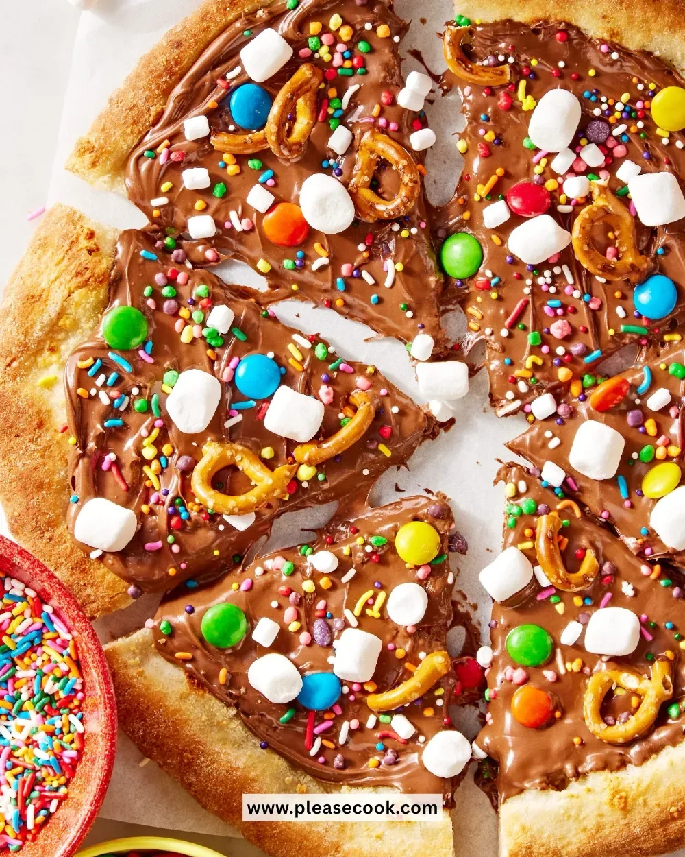 Delicious chocolate pizza topped with fruits and nuts, a creative dessert recipe.