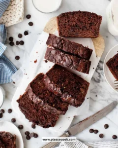 Freshly baked chocolate zucchini bread on a wooden cutting board.