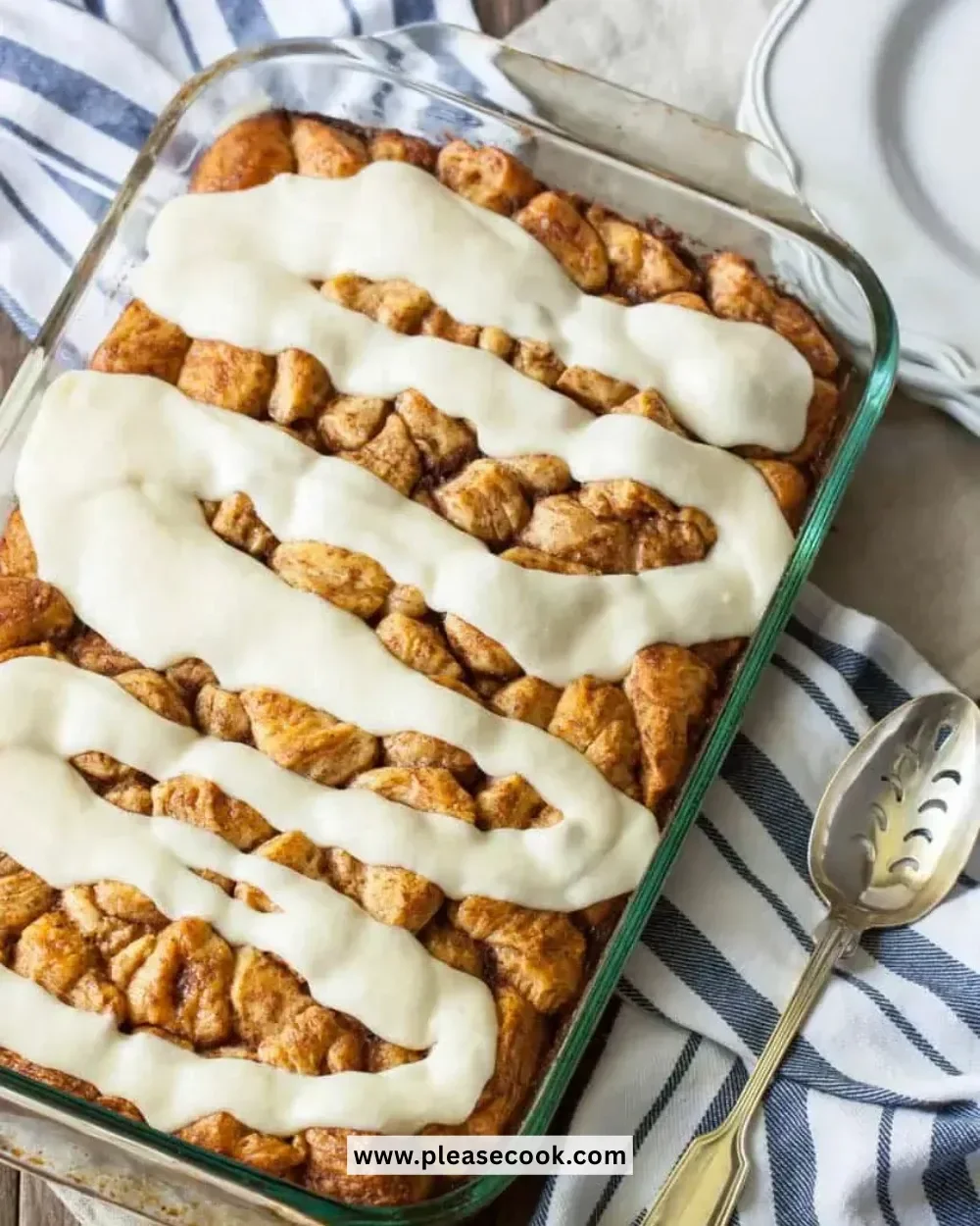 Delicious cinnamon roll casserole served warm with icing drizzle