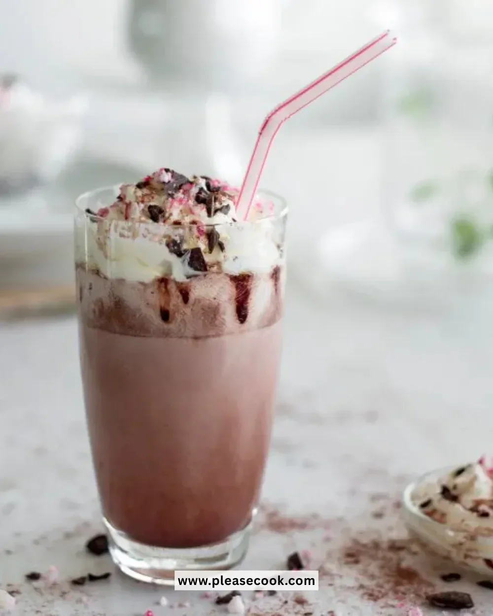 Delicious Cola Cao chocolate milkshake in a glass with whipped cream.