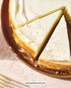 Slice of creamy eggnog cheesecake topped with whipped cream and festive spices