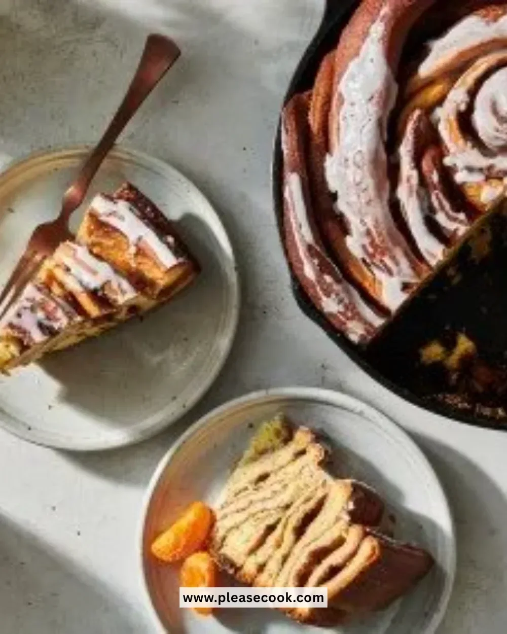 A giant cinnamon roll with icing on a plate, freshly baked and golden brown