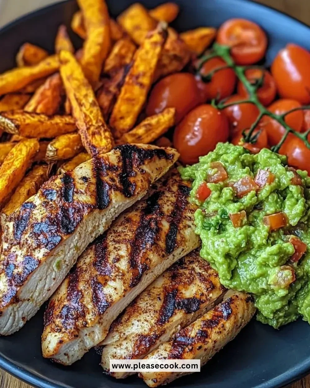 Plate of grilled chicken with sweet potato fries and chunky guacamole