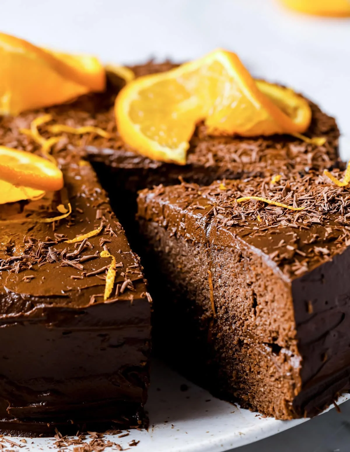 Slice of healthy chocolate orange cake garnished with orange zest