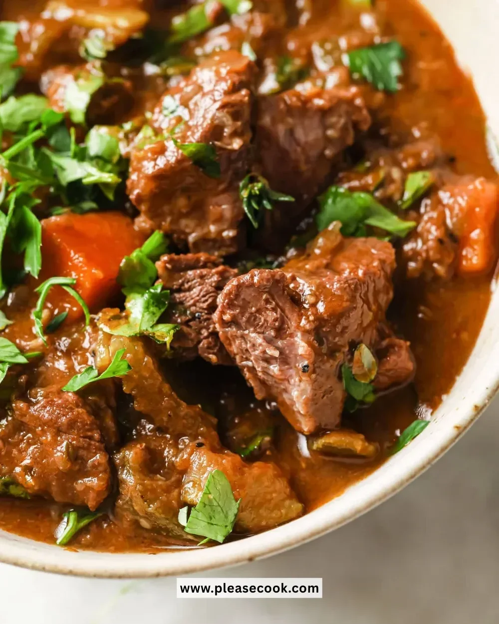A bowl of hearty low carb keto beef stew garnished with fresh herbs