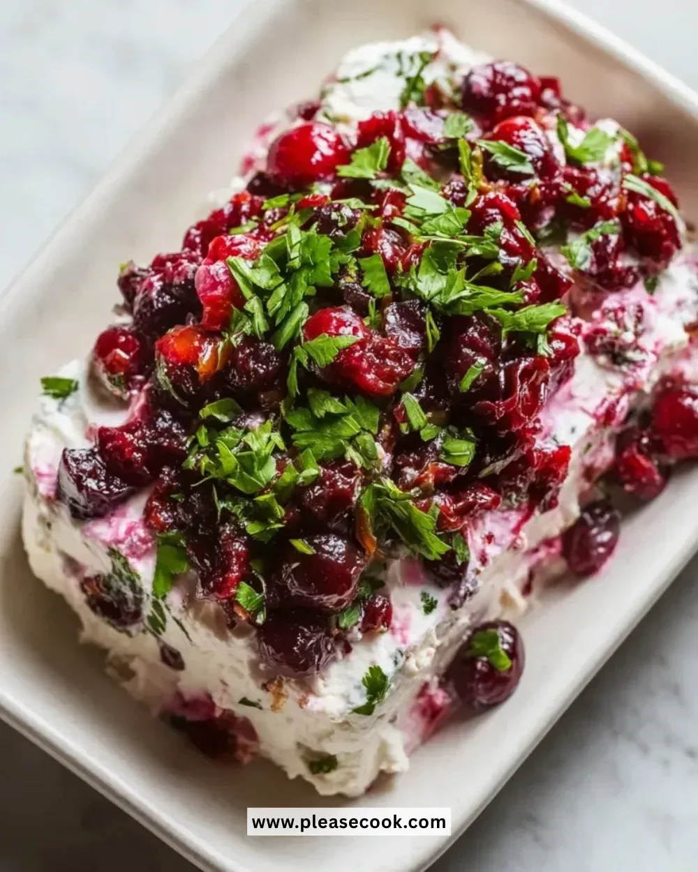 Holiday cranberry jalapeño cream cheese dip served in a festive bowl