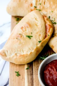 Freshly baked homemade calzones filled with cheese and vegetables