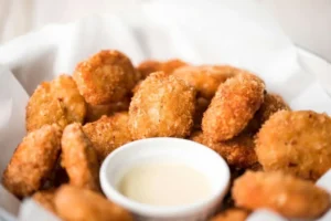Plate of homemade chicken nuggets with dipping sauce