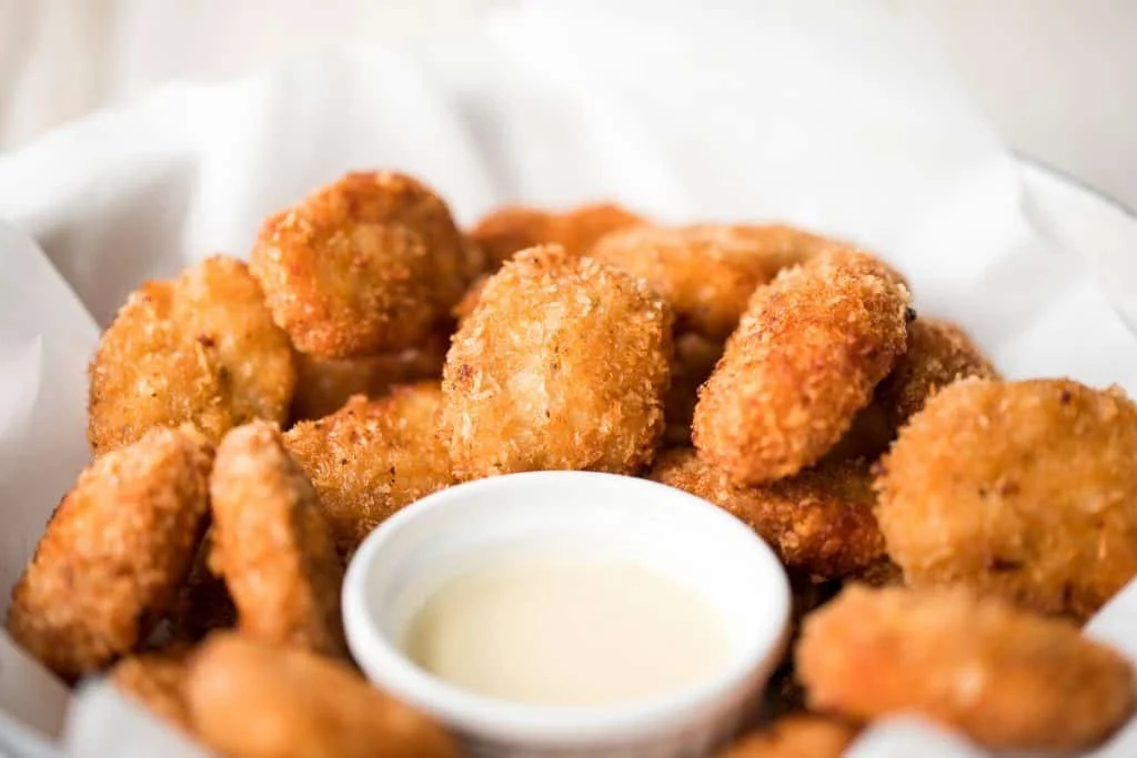 Plate of homemade chicken nuggets with dipping sauce