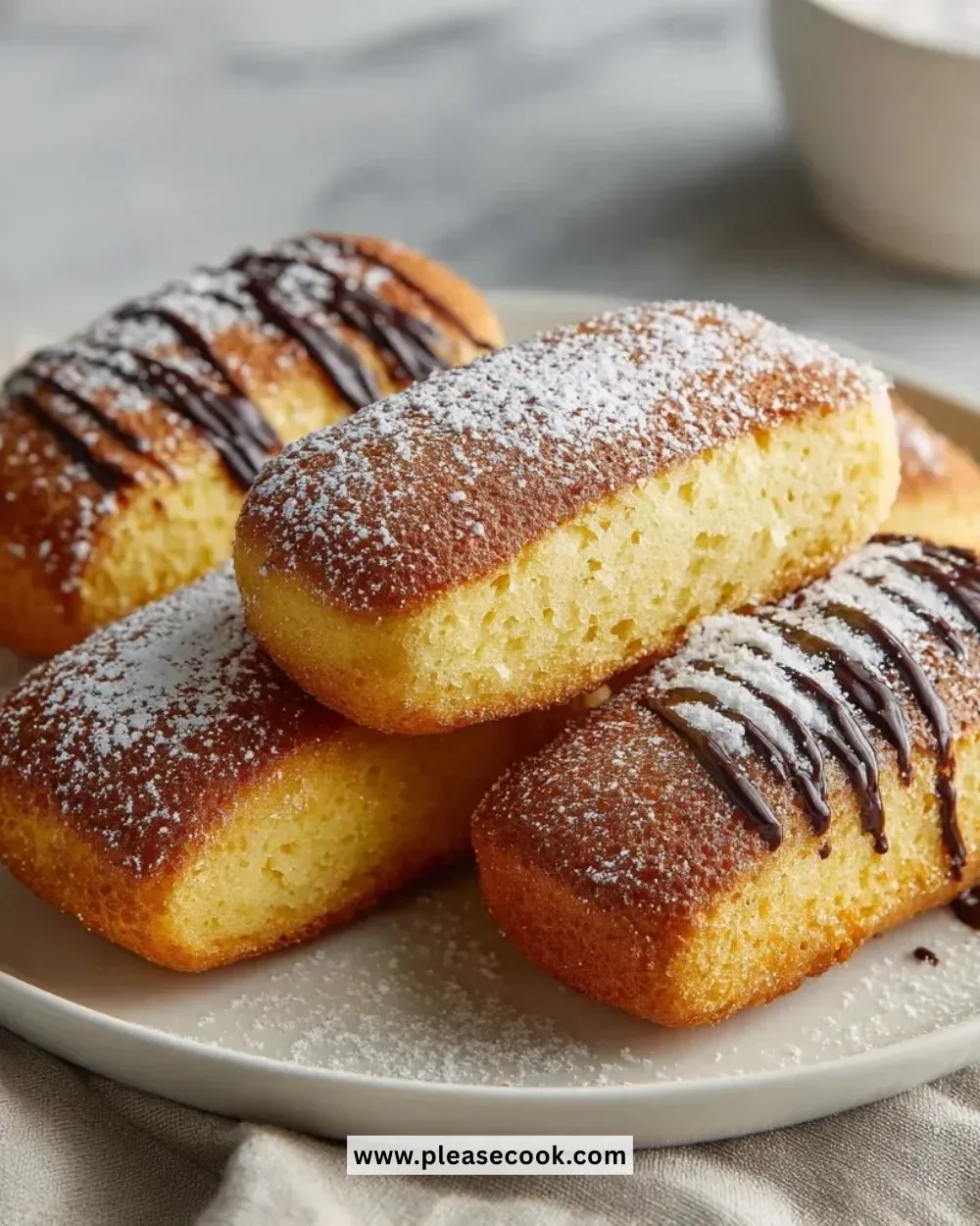 Delicious homemade Twinkies on a plate, freshly baked and inviting.