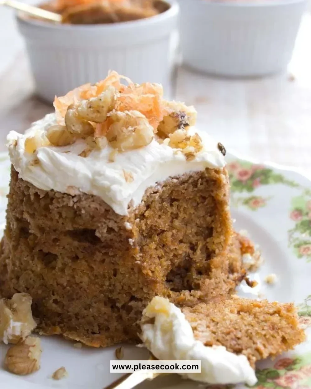 Delicious Keto Carrot Cake topped with creamy frosting on a wooden table