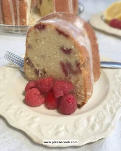 Slice of Lemon Raspberry Pound Cake with fresh raspberries and lemon zest