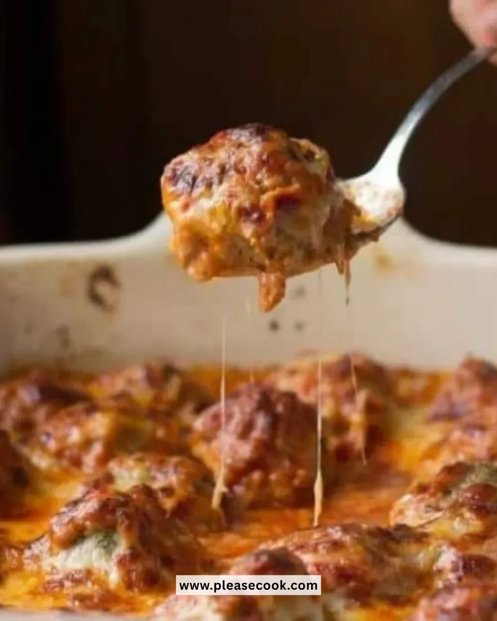 Delicious Meatball Casserole Parmesan served in a baking dish with melted cheese on top.