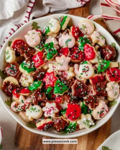 An assortment of mini Christmas cookies decorated with icing and sprinkles.