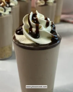 No-bake chocolate milkshake cheesecake cups topped with chocolate drizzle.