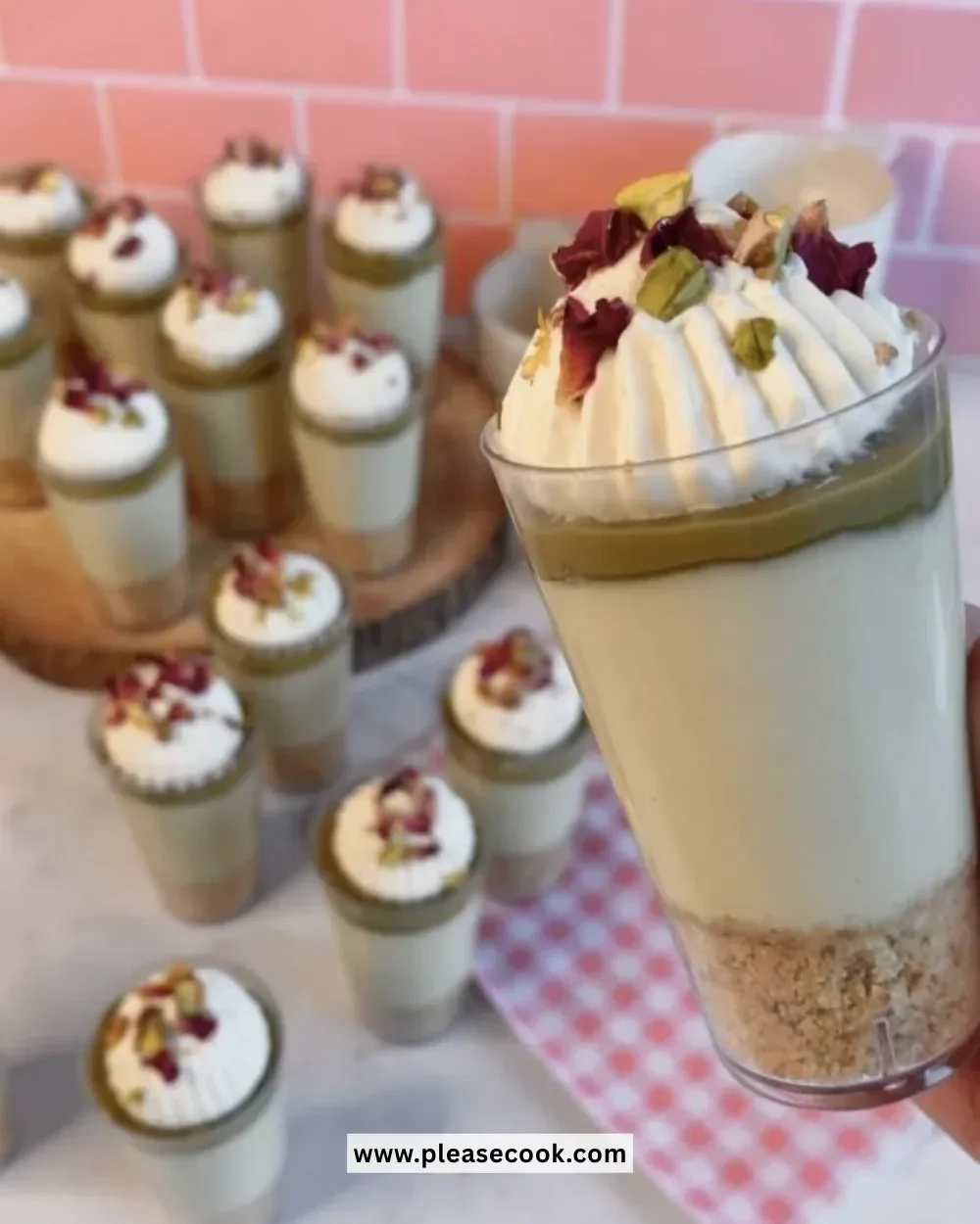 No-bake pistachio cheesecake cups topped with crushed pistachios.