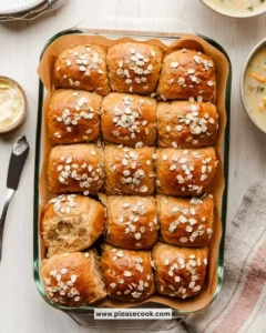 Freshly baked Oatmeal Molasses Dinner Rolls on a wooden table