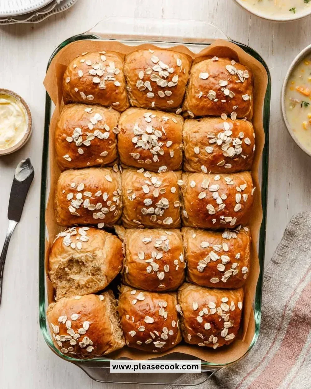 Freshly baked Oatmeal Molasses Dinner Rolls on a wooden table