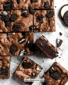 Delicious Oreo brownies topped with crushed Oreo cookies and chocolate drizzle.