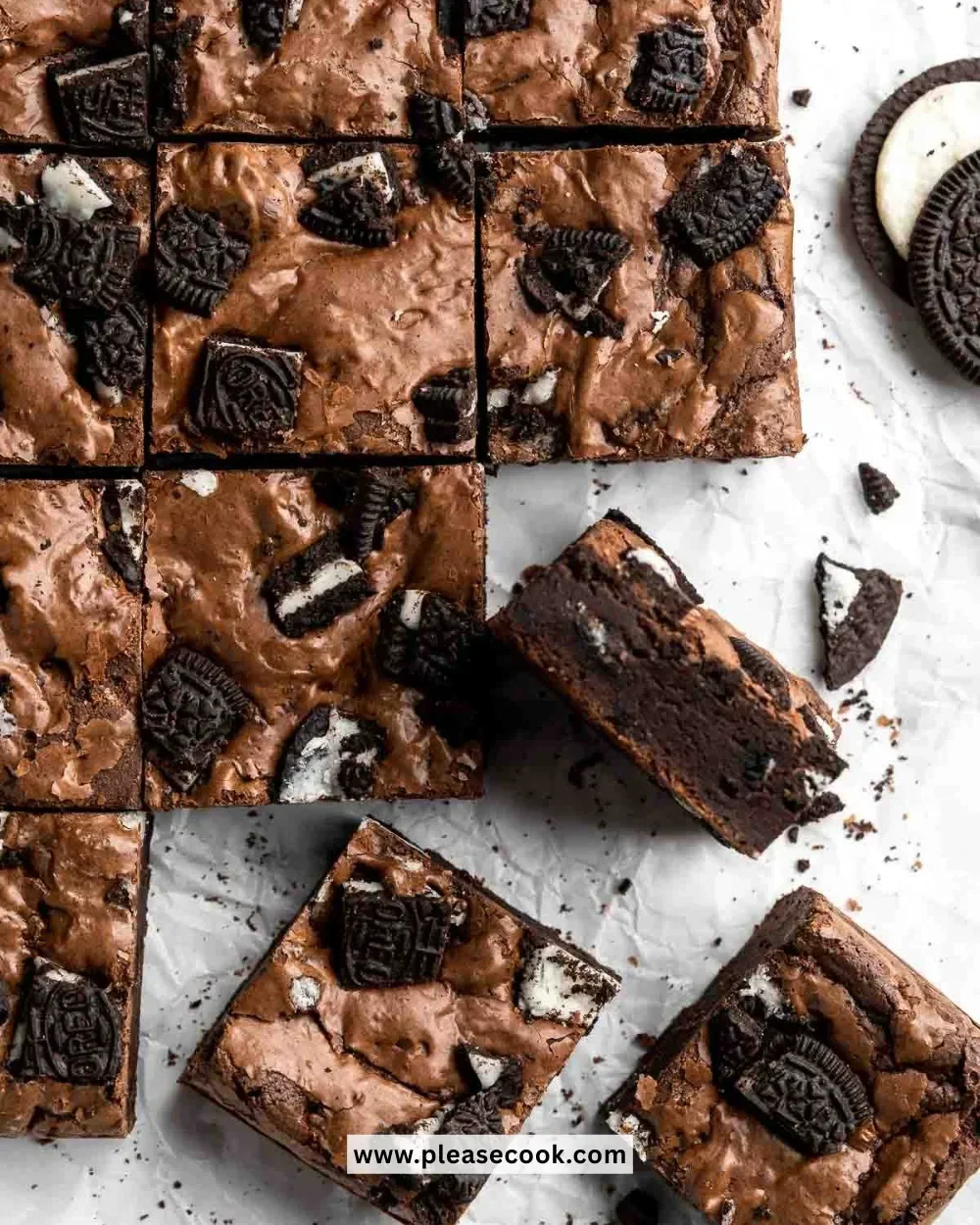Delicious Oreo brownies topped with crushed Oreo cookies and chocolate drizzle.
